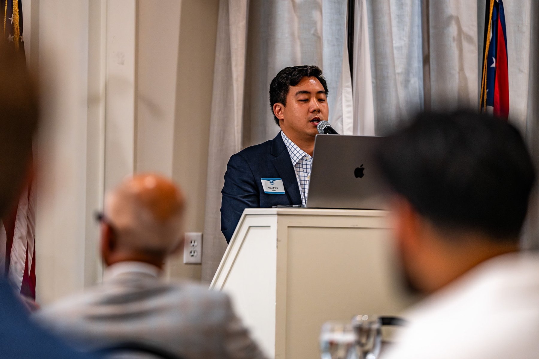 A speaker presenting at the forum